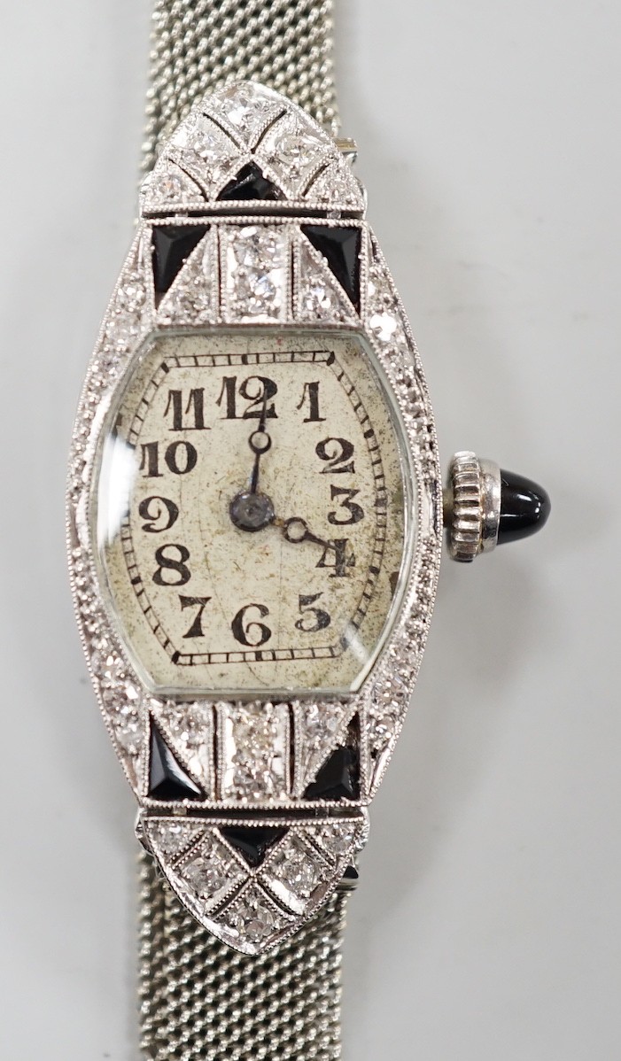 An Art Deco white metal (stamped platine) black onyx and diamond cluster set cocktail watch, on a 750 white mesh bracelet, approx. 16cm, gross weight 18.7 grams.
